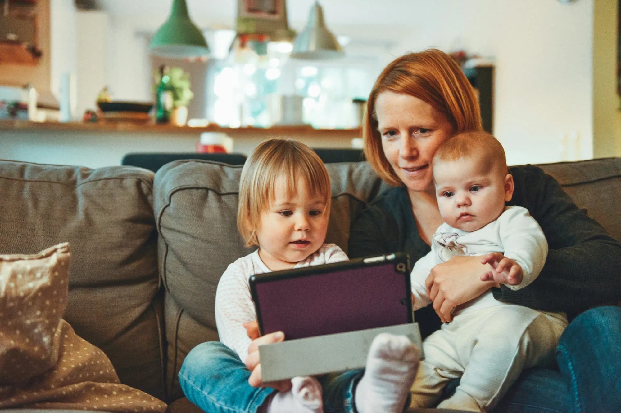 mamá con sus dos hijos en el sillón