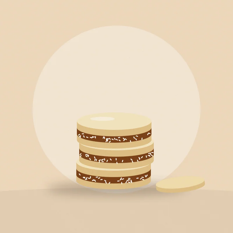 Pila de tres alfajores de maicena con dulce de leche y coco en el borde